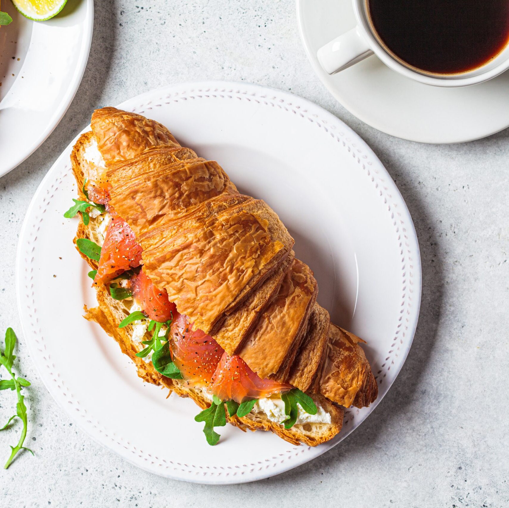 Croissant,Sandwich,With,Cream,Cheese,,Salmon,And,Arugula,On,A