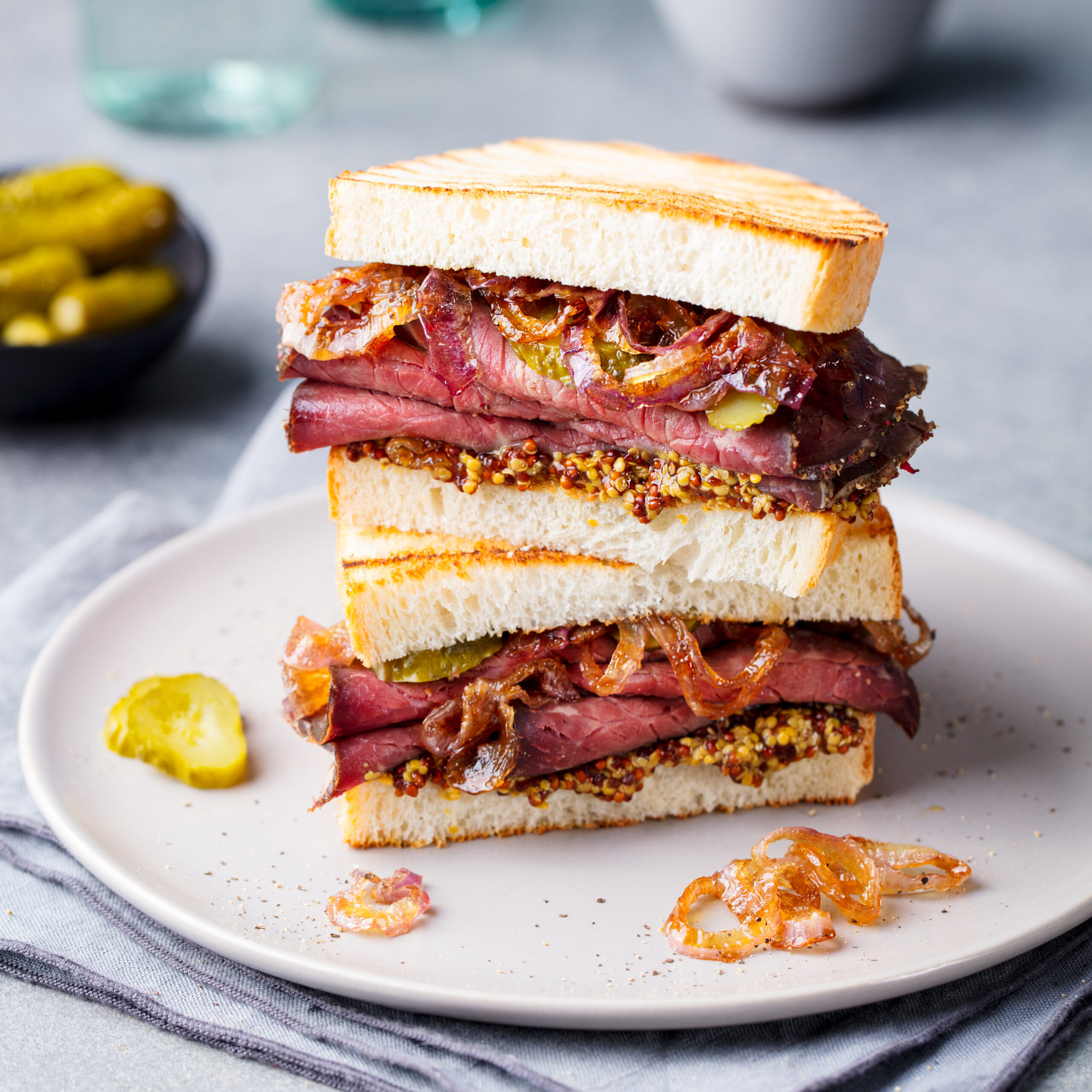 Roast,Beef,Sandwich,On,A,Plate,With,Pickles.,Close,Up.